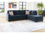 Blue fabric L-shaped sectional sofa with chaise in modern living room.