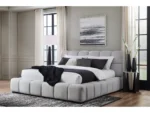 Modern upholstered gray bed in minimalist bedroom with black and white bedding and large windows